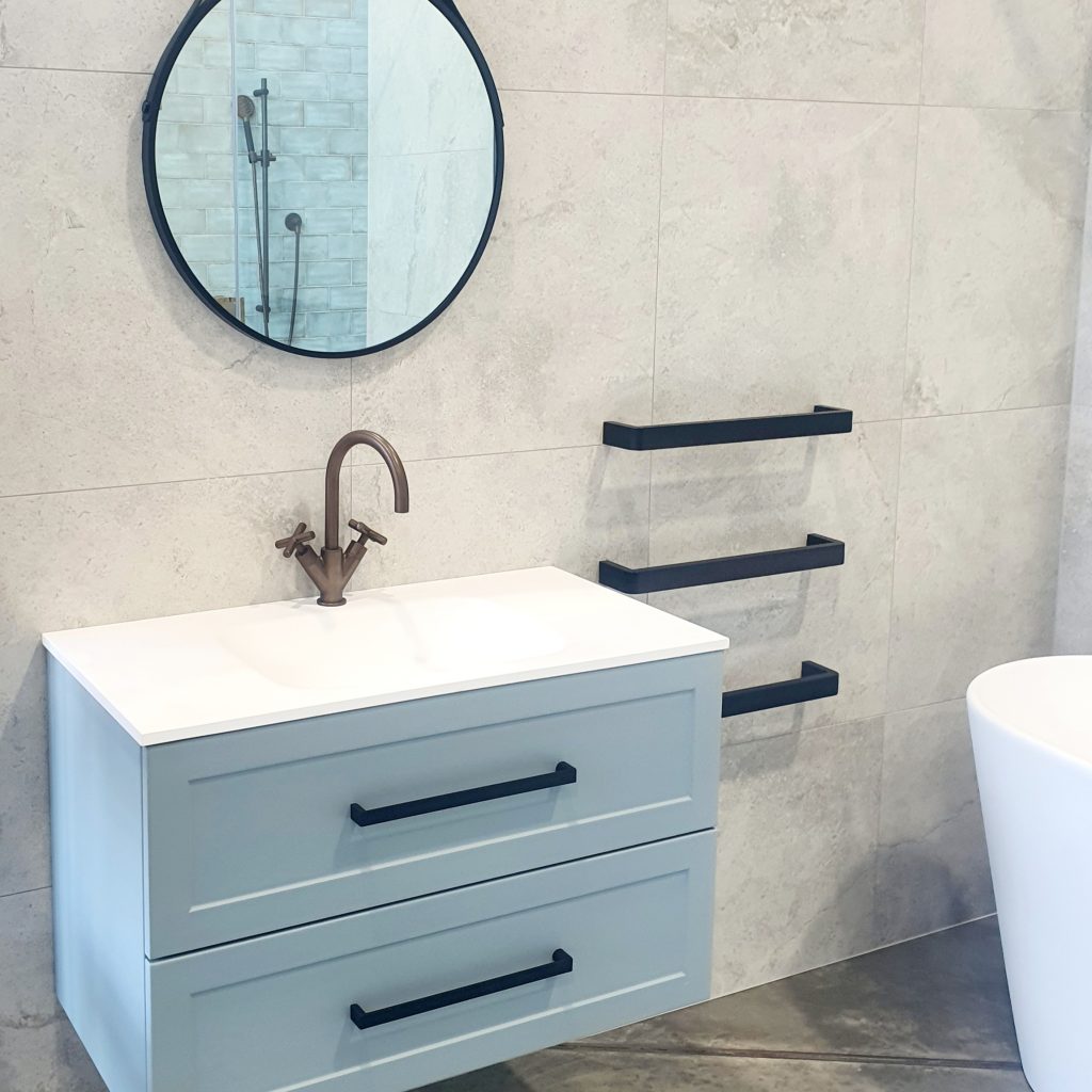 Wall hung 2 drawer vanity. Thin vanity top with a matte finish. There handles have been swapped here from a standard chrome, to a black finish in square look to match the heated towel rails. 
