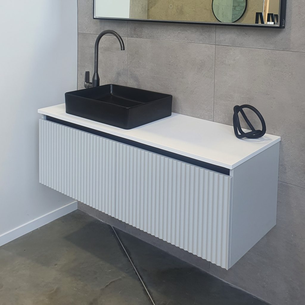 Wall hung with slab top and square top mounted vessel basin. A taller mixer is used here to suit the basin install. Note the handles are recessed here instead of put onto the front. 